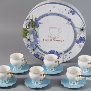 Blue coffee cup and saucer set of six in front of round floral gift box